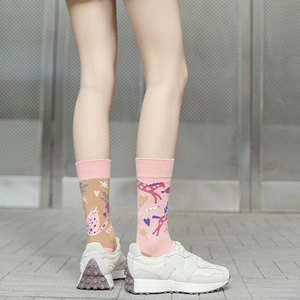 Close-up of asymmetrical mid-calf cotton socks with cartoon cat and horse patterns