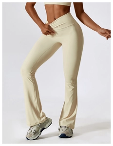 Detail view of high-waisted flared yoga pants with a crossover V-shape waistband design