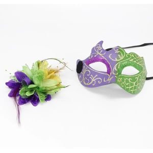 Detail of purple and green masquerade mask set with feather floral headpiece on white background