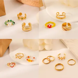 Detail of luxury gold titanium steel ring sets with heart, star and bead designs