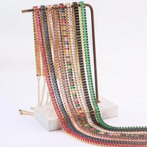 Detail of colorful zircon tennis bracelets with gold plating on marble stand