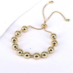 Adjustable golden bead bracelet with slider closure and sparkling crystal charms