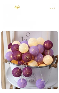 Detail of warm LED cotton ball string lights in purple and white colors for room decor