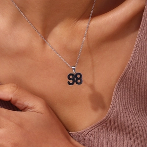 Silver number 98 pendant necklace on a delicate chain worn by a fashion model
