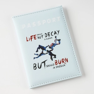 Close-up of light blue faux leather passport cover with printed inspirational quote