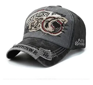 Detail of vintage washed baseball cap featuring shark embroidery and distressed patches