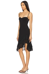 Detail view of ruffle hem with sheer mesh patchwork on black slim fit slip dress