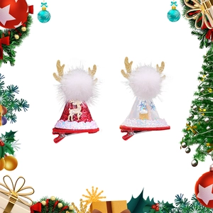 Detail of Christmas pet hair clips featuring red glitter antlers and snowflake accents