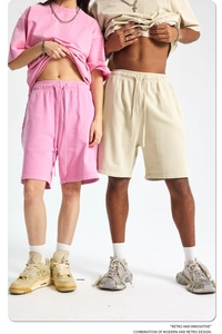 Matching set of pink and apricot cotton knit short sleeve t-shirts and sports shorts