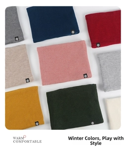 Detailed view of ribbed knit neck warmers in multiple colors with circular brand tags