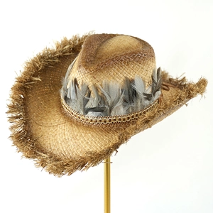 Close-up of cowboy straw hat featuring real feather trim and elegant gold chain detail
