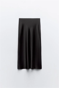 Detailed view of black satin midi skirt with glossy silk texture and elegant draping