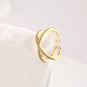 Macro detail of gold-plated crossover ring featuring micro-pave white zircon stones