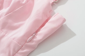 Macro shot of pink dress detail with seamless invisible zipper and fine stitching