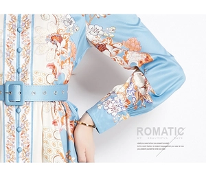 Close-up of floral print satin dress featuring fabric buttons and a slim blue waist belt