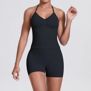 Detail of seamless black workout set featuring ribbed V-neck top and high waist shorts