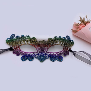 Rainbow gradient lace masquerade mask with hollow design and black ribbon on white background