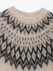 Detail of round neckline and geometric jacquard pattern on plush alpaca wool knitwear