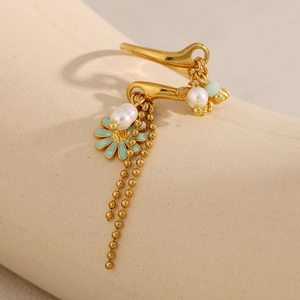 Detail of 18K gold plated ring with blue enamel flower and hanging pearl tassels