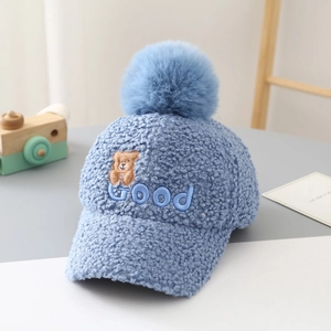 Detailed blue teddy fleece baseball cap featuring a cute bear patch and plush pom-pom