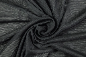 Close-up of black breathable mesh fabric texture with elegant spiral fold pattern