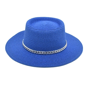 Close-up of royal blue straw hat featuring flat top and chic silver metal chain trim
