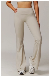 Close-up of high-waisted beige flared yoga pants with elastic slimming waist design