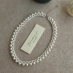 Elegant double-layered white pearl beaded necklace with adjustable silver extension chain