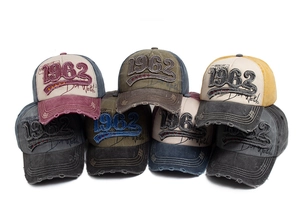 Detail of distressed cotton baseball caps with 1962 embroidery and frayed edges