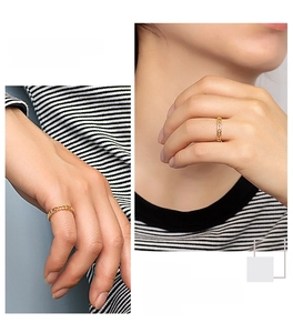 Detail of golden heart hollow ring showing fashion design on a model's hand