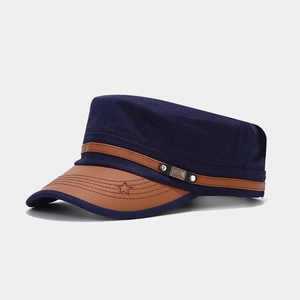 Detail of navy cotton military cap showing brown leather brim and star embroidery