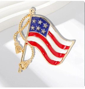 Detailed close-up of a gold US flag brooch with red white enamel and sparkling rhinestones