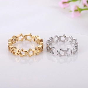 Detailed macro of hollow star titanium steel rings in gold and silver brushed metal finish