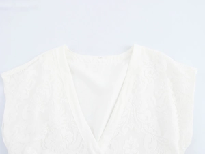 Nahaufnahme des eleganten weißen V-Ausschnitts mit aufwendiger floraler Jacquard-Spitze