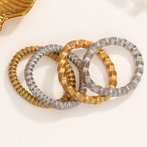 Set of 4 twisted wave pattern bangles in polished gold and silver plated stainless steel