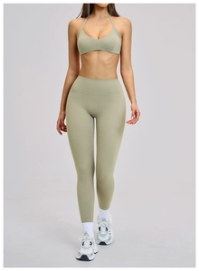 Sage green high-waisted yoga set with cross strap sports bra and leggings for women
