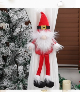 Close-up of Christmas gnome curtain buckle on fabric with festive holiday background