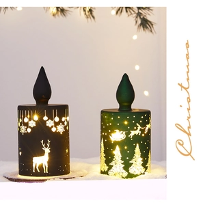 Detailed view of LED Christmas candle lanterns with reindeer and pine tree silhouettes