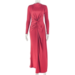 Detail of red long-sleeved dress showing the waist knot and ruched texture fabric