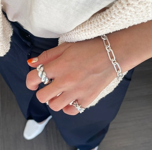 Detail shot of minimalist S925 sterling silver chunky twisted ring and star shaped ring