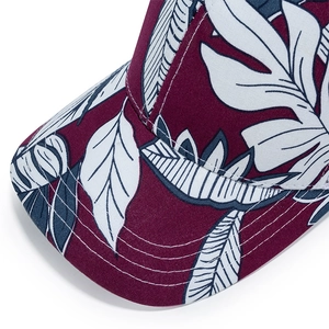 Burgundy baseball cap with white tropical leaf prints and reinforced stitching details