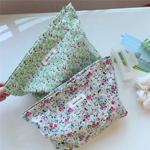 Detail showing high-quality floral cotton canvas makeup bags with small flower patterns