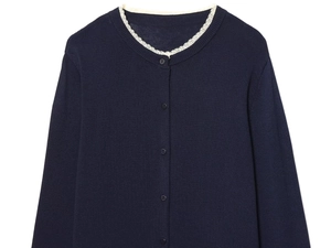 Detailed view of the navy blue knit cardigan featuring white lace trim and button closure