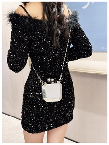 Silver octagon acrylic clutch bag with metal chain shown on a black sequin dress