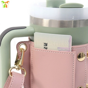 Pink lychee grain leather cup sleeve with functional card slot and gold hardware detail