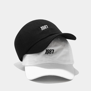 Classic 1987 embroidered baseball caps in black and white colors for a trendy look