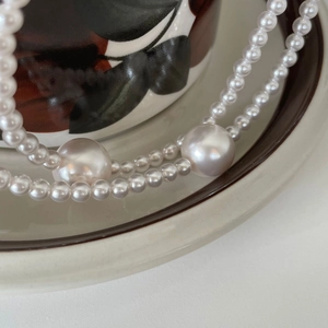 Elegant 925 sterling silver pearl necklace featuring large central pearls and a glossy finish