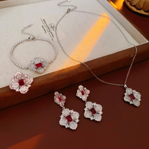 Silver jewelry set with red rectangle gemstones and floral diamond halo details