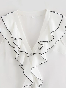 Detail of white ruffled collar blouse with black contrast trim and size S label