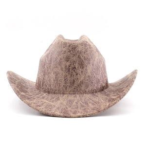 Detailed macro view of the distressed vintage crackle texture on dark brown cowboy hat